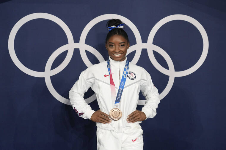 ASSOCIATED PRESS / AUG. 3
                                Simone Biles poses wearing her bronze medal from balance beam competition during artistic gymnastics at the 2020 Summer Olympics in Tokyo in August. President Joe Biden will present the nation’s highest civilian honor, the Presidential Medal of Freedom, to Biles and 16 other people, at the White House next week.