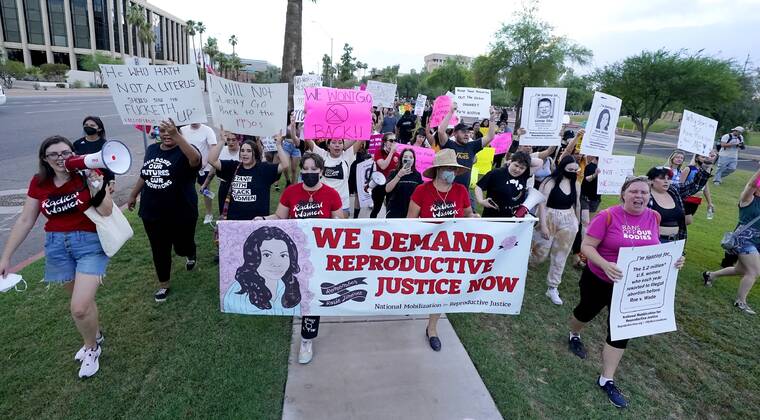 ASSOCIATED PRESS / June 24
                                Thousands of protesters march around the Arizona Capitol in protest after the Supreme Court decision to overturn the landmark Roe v. Wade abortion decision last week in Phoenix. In Arizona, Republicans are fighting among themselves over whether a 121-year-old anti-abortion law that precedes statehood should be enforced over a 2022 version.