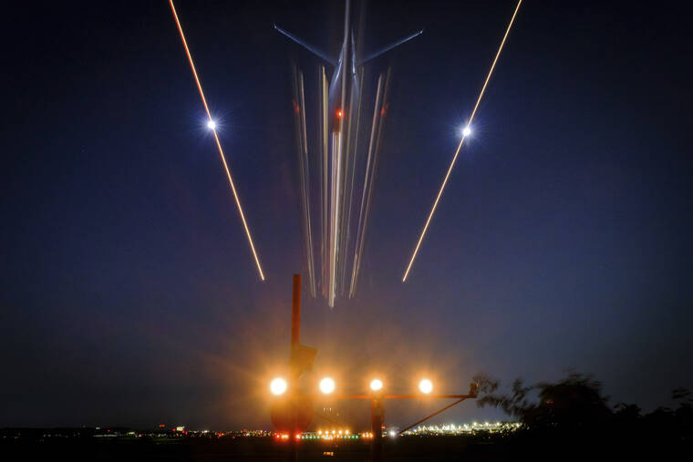 ASSOCIATED PRESS
                                A passenger jet streaks toward a landing at Reagan National Airport in Arlington, Va, Thursday evening. Heavy travel is expected over the Fourth of July holiday in the United States.
