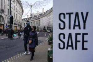 ASSOCIATED PRESS / NOV. 28
                                People wear face masks as they walk, in Regent Street in London in November. The number of new coronavirus cases across Britain has surged by more than 30% in the last week, with cases largely driven by the super infectious omicron variants.