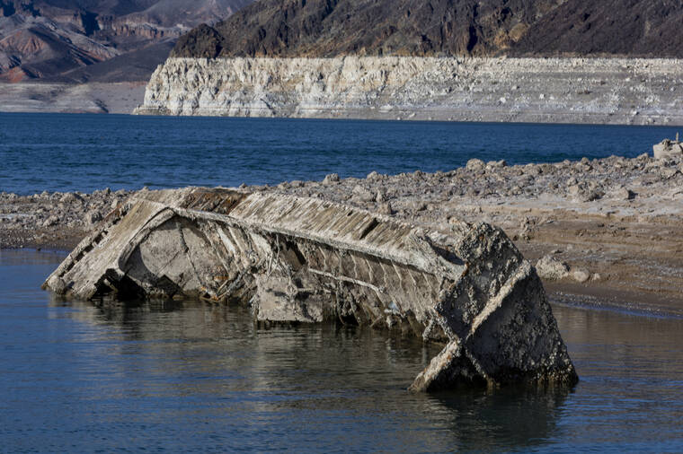 L.E. BASKOW/LAS VEGAS REVIEW-JOURNAL VIA AP / JUNE 30
                                A WWII ear landing craft used to transport troops or tanks was revealed on the shoreline near the Lake Mead Marina as the waterline continues to lower at the Lake Mead National Recreation Area in Boulder City.