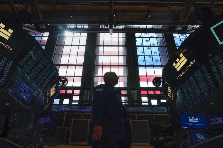 ASSOCIATED PRESS
                                Traders work on the floor at the New York Stock Exchange in New York.
