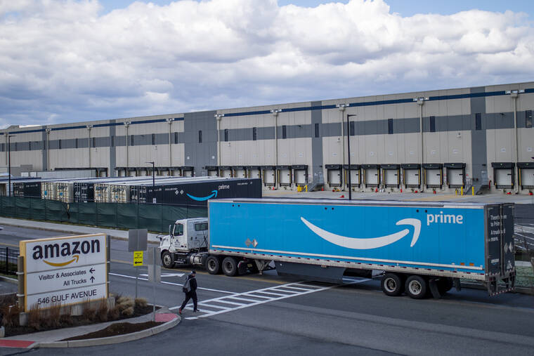ASSOCIATED PRESS
                                A truck arrives at the Amazon warehouse facility on the Staten Island borough of New York. Amazon is barring off-duty warehouse workers from the company’s facilities, a move organizers say can hamper union drives.