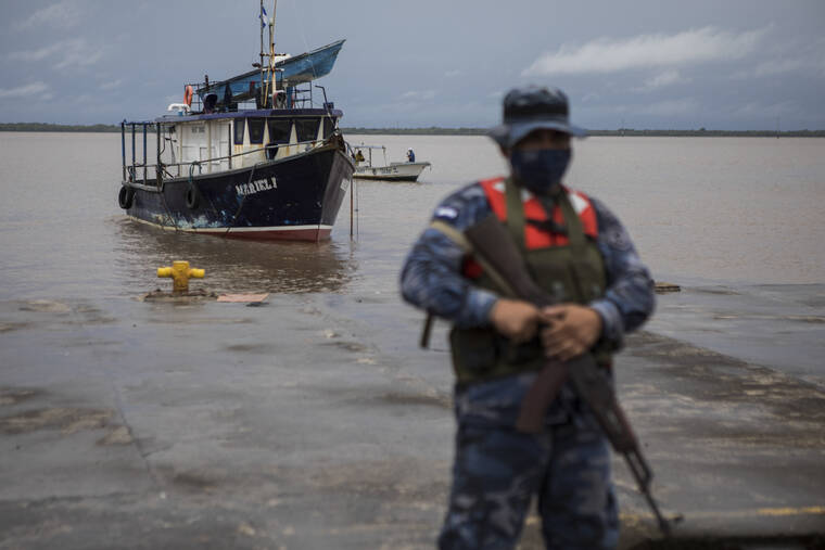 INTI OCON / AP
                                A Navy soldier stands guard as authorities wait for the arrival of people who were evacuated from the Monkey Point community, at the port in Bluefields, Nicaragua, Friday.