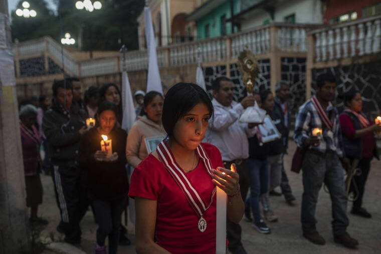 ASSOCIATED PRESS / JUNE 30
                                Residents hold a candlelight vigil to pray for three local teenagers in hopes they are not among the 53 migrants who died in a stifling, abandoned trailer in Texas, in San Marcos Atexquilapan, Veracruz state, Mexico. One of the three teens, Misael, was later confirmed to have perished in the trailer while the fate of Jair and Yovani remained unknown.