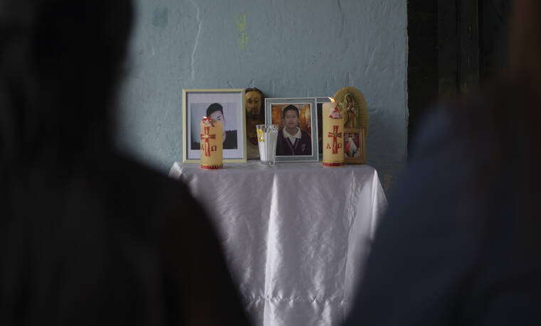 ASSOCIATED PRESS / JUNE 30
                                An improvised altar with the photographs of brother’s Yovani and Jair Valencia Olivares, stands outside their home in San Marcos Atexquilapan, Veracruz state, Mexico. Neighbors prayed for the brothers and a cousin who are missing after confirming that they were traveling in the abandoned trailer in San Antonio, Texas where more than 50 bodies were found.