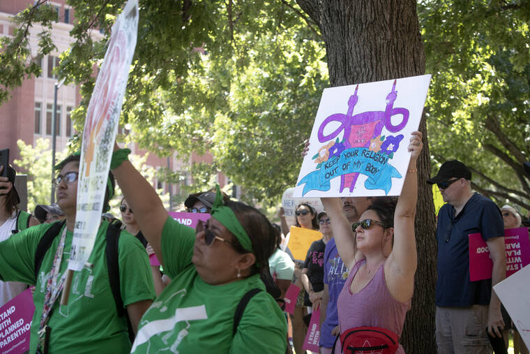 STAR-TELEGRAM VIA AP
                                Abortion-rights advocates gather outside the Tarrant County Courthouse during the Bans Off Our Bodies protest in Fort Worth, Texas, on June 25.