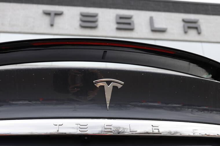 ASSOCIATED PRESS / 2020
                                The company logo shines off the rear deck of an unsold 2020 Model X at a Tesla dealership in Littleton, Colo.