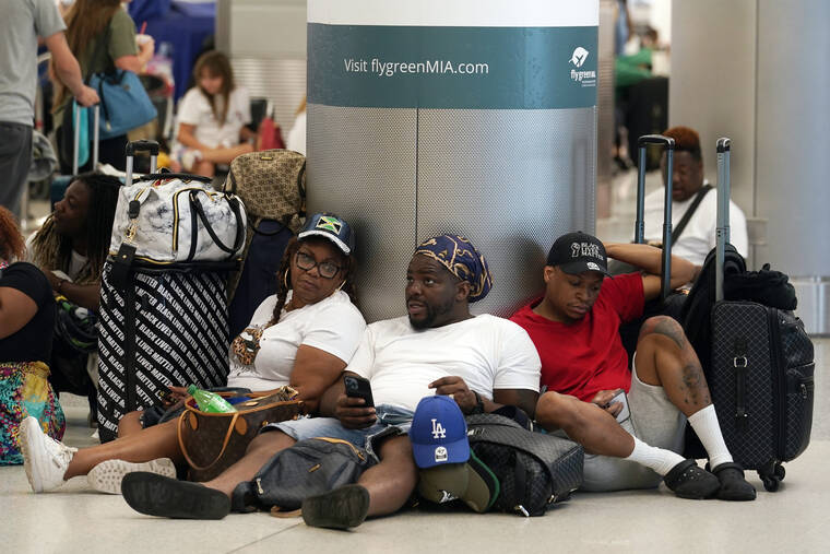MARTA LAVANDIER / AP
                                Alisson Bryan, Marcel Bryan and Terry Craig, wait to check-in their luggage for their flight home to Missouri at Miami International Airport, Saturday, in Miami. The group was on a cruise ship vacation in the Caribbean.