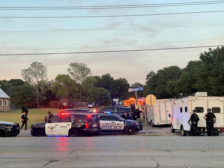 JAMES HARTLEY/STAR-TELEGRAM VIA AP / JULY 2
                                Law enforcement work the scene where multiple shots were fired near the area of Cedarcrest Drive and Diamond Oaks Drive in Haltom City, Texas.