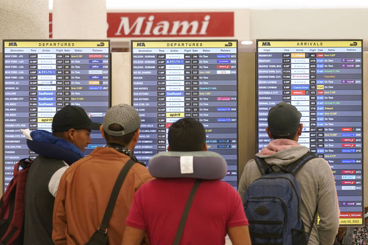 ASSOCIATED PRESS
                                Travelers check their flights at Miami International Airport, Saturday, in Miami. The Fourth of July holiday weekend is jamming U.S. airports with the biggest crowds since the pandemic began in 2020.
