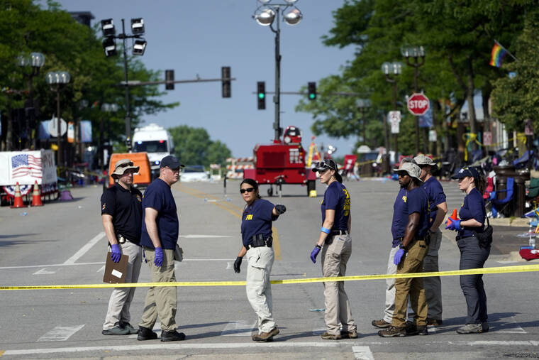 ASSOCIATED PRESS
                                Members of the FBI’s evidence response team organize one day after a mass shooting in downtown Highland Park, Ill. today. A shooter fired on an Independence Day parade from a rooftop spraying the crowd with gunshots initially mistaken for fireworks before hundreds of panicked revelers of all ages fled in terror.