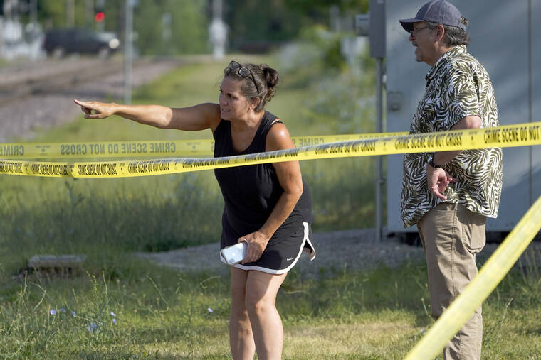 ASSOCIATED PRESS
                                Two pedestrians look into downtown Highland Park, Ill., behind police tape one day after a mass shooting in the northern Chicago suburb, today. A shooter fired on an Independence Day parade from a rooftop spraying the crowd with gunshots initially mistaken for fireworks before hundreds of panicked revelers of all ages fled in terror.
