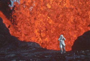NATIONAL GEOGRAPHIC VIA AP
                                Katia Krafft wearing an aluminized suit as she stands near lava burst at Krafla Volcano, Iceland, in a scene from the documentary “Fire of Love.”
