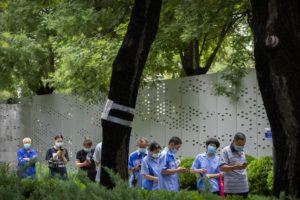 ASSOCIATED PRESS
                                People wearing face masks stand in line for COVID-19 tests at a coronavirus testing site in Beijing on Wednesday.