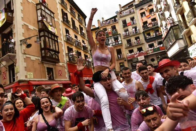 ASSOCIATED PRESS
                                Revelers celebrate while waiting for the launch of the ‘Chupinazo’ rocket, to mark the official opening of the 2022 San Fermin fiestas in Pamplona, Spain, today. The blast of a traditional firework opens today nine days of uninterrupted partying in Pamplona’s famed running-of-the-bulls festival which was suspended for the past two years because of the coronavirus pandemic.