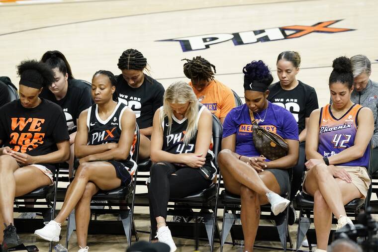 ROSS D. FRANKLIN / AP
                                Phoenix Mercury players bow their heads in prayer at a rally for WNBA basketball teammate Brittney Griner Wednesday in Phoenix.