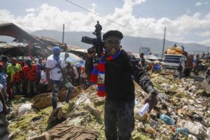 ASSOCIATED PRESS
                                Barbecue, the leader of the “G9 and Family” gang, stands next to garbage to call attention to the conditions people live in as he leads a march against kidnapping through La Saline neighborhood in Port-au-Prince, Haiti, on Oct. 22.