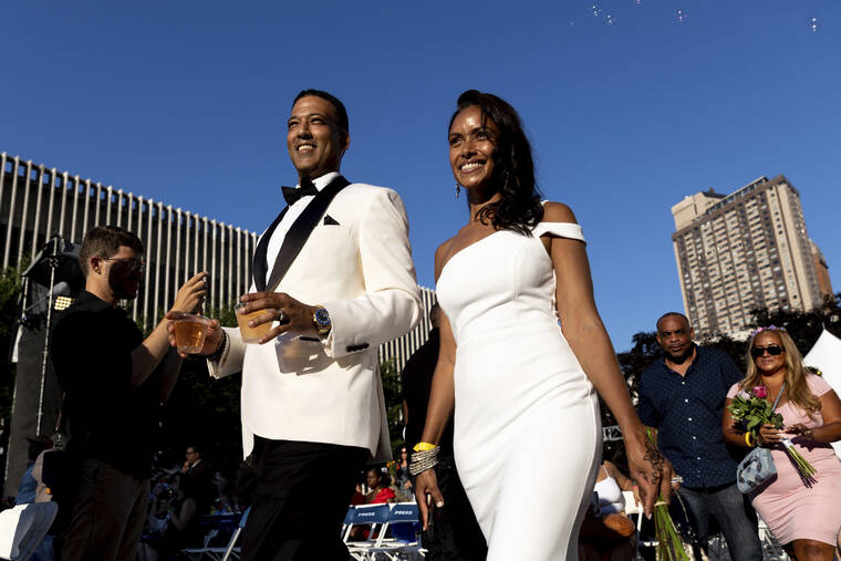 ASSOCIATED PRESS Couples, whose weddings were canceled or diminished during the COVID-19 pandemic, participate in a symbolic multicultural ceremony at Damrosch Park in New York. The evening culminated with a reception on the dance floor at The Oasis and is a part of Lincoln Centers Summer for the City.
