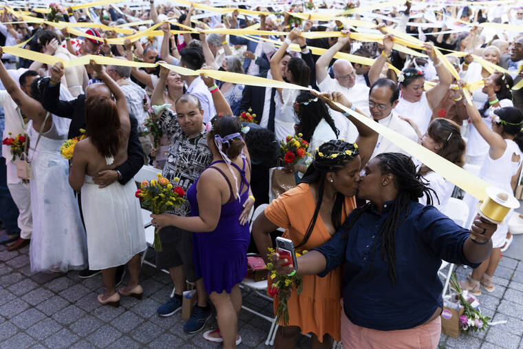 ASSOCIATED PRESS Couples, whose weddings were canceled or diminished during the COVID-19 pandemic, participate in a symbolic multicultural ceremony at Damrosch Park in New York. The evening culminated with a reception on the dance floor at The Oasis and is a part of Lincoln Centers Summer for the City.