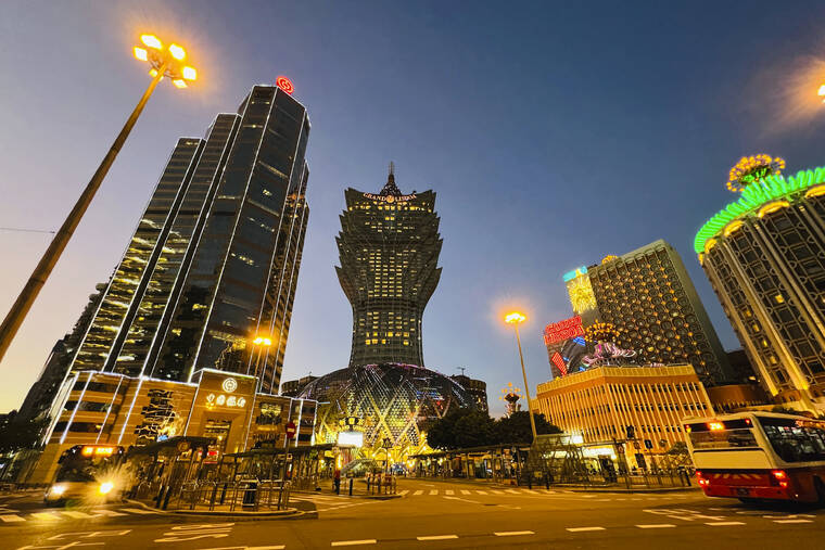 ASSOCIATED PRESS / JULY 11 Grand Lisboa, center, is closed in Macao, Monday, July 11. Streets in the gambling center of Macao were empty Monday after casinos and most other businesses were ordered to close while the Chinese territory near Hong Kong fights a coronavirus outbreak.