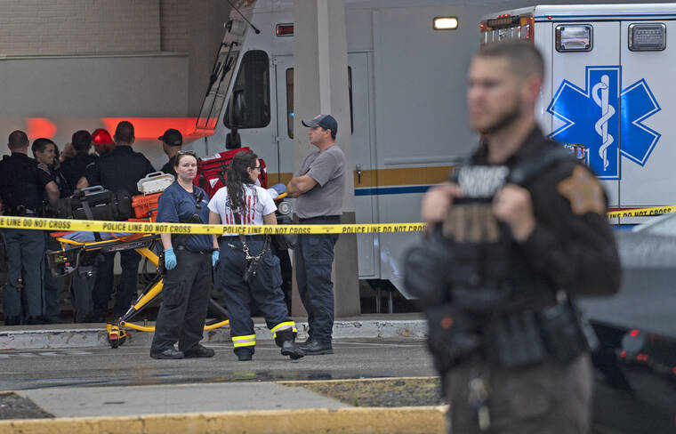 KELLY WILKINSON/THE INDIANAPOLIS STAR VIA AP
                                Emergency personnel gathers after a deadly shooting at the Greenwood Park Mall, in Greenwood, Ind.