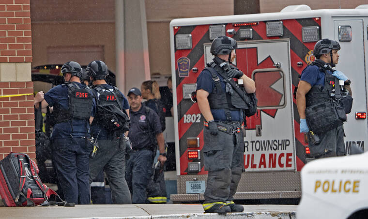 KELLY WILKINSON/THE INDIANAPOLIS STAR VIA AP
                                Law enforcement waits outside after a deadly shooting at the Greenwood Park Mall, in Greenwood, Ind.