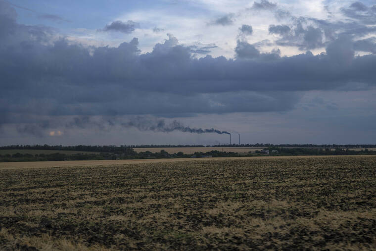 ASSOCIATED PRESS
                                Grain fields backdropped by a power plant in Donetsk region in eastern Ukraine on Friday.