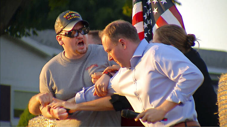 WHEC-TV / AP
                                In this image taken from video provided by WHEC-TV, David Jakubonis, left, is subdued as he brandishes a sharp object during an attack U.S. Rep. Lee Zeldin, right, as the Republican candidate for New York governor delivered a speech in Perinton, N.Y., Thursday.