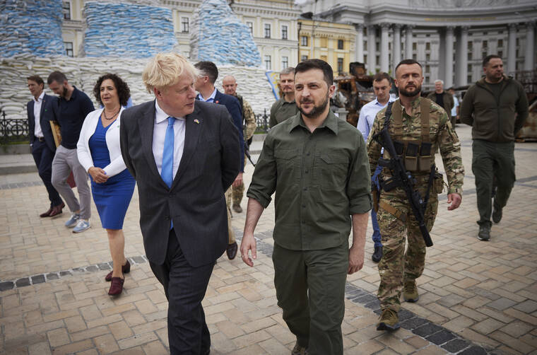 UKRAINIAN PRESIDENTIAL PRESS OFFICE / AP / JUNE 17
                                FILE - In this image provided by the Ukrainian Presidential Press Office, Ukrainian President Volodymyr Zelenskyy, centre, and Britain’s Prime Minister Boris Johnson walk on the square where damaged Russian military vehicles are displayed in Kyiv, Ukraine.