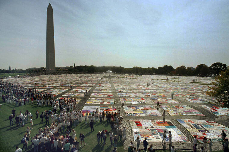 ASSOCIATED PRESS / JULY 27
                                People visit the 21,000 panel Names Project AIDS Memorial Quilt in Washington on Saturday, Oct. 10, 1992. The Washington Monument is seen in the background. Hard-won progress against HIV has stalled, putting millions of lives at risk, according to an alarming report on how the collision with the COVID-19 pandemic and other global crises is jeopardizing efforts to end AIDS. The report from UNAIDS is being released ahead of the start of the International AIDS Conference later this week.