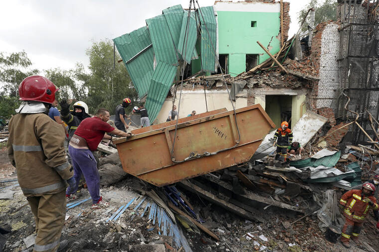 ASSOCIATED PRESS / JULY 26
                                Rescuers remove debris after a Russian missile attack on Monday in Chuhuiv, Kharkiv region, Ukraine.