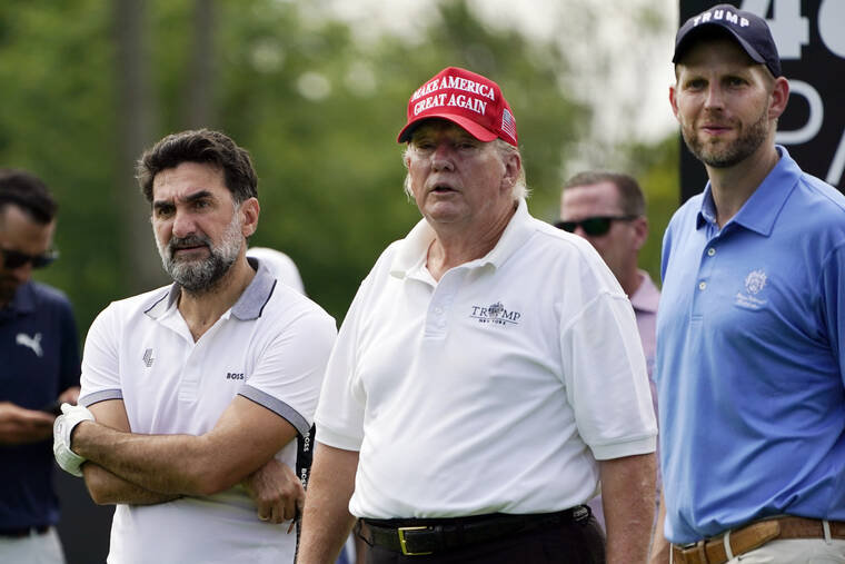 ASSOCIATED PRESS
                                Yasir Al-Rumayyan, left, a governor of Saudi Arabia’s Public Investment Fund, which is financing the LIV Golf series, former President Donald Trump, center, and his son Eric Trump, watch play in the pro-am round of the Bedminster Invitational LIV Golf tournament in Bedminster, NJ., today.