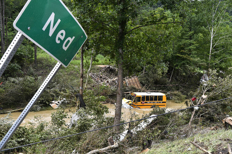 TIMOTHY D. EASLEY / AP
                                A Perry County school bus lies destroyed after being caught up in the floodwaters of Lost Cree in Ned, Ky., Friday, July 29.