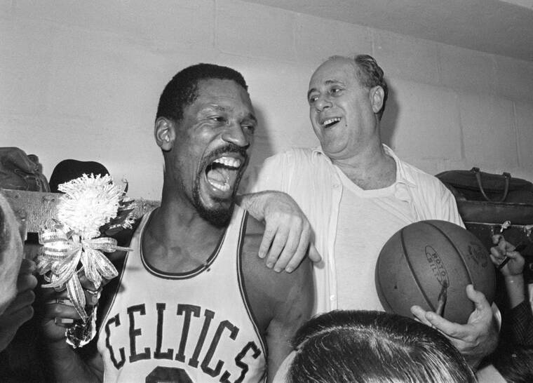 ASSOCIATED PRESS / APRIL 29, 1966
                                Boston Celtics’ Bill Russell, left, holds a corsage sent to the dressing room as he celebrates with Celtics coach Red Auerbach after defeating the Los Angeles Lakers, 95-93, to win their eighth-straight NBA Championship, in Boston. The NBA great Bill Russell has died at age 88. His family said on social media that Russell died on Sunday, July 31. Russell anchored a Boston Celtics dynasty that won 11 titles in 13 years.
