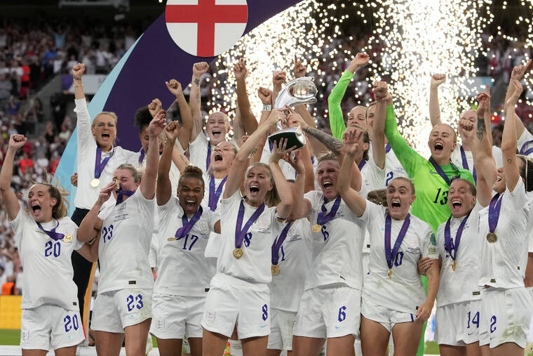 ASSOCIATED PRESS
                                England’s Leah Williamson, center left, and Millie Bright lift the trophy after winning the Women’s Euro 2022 final soccer match between England and Germany at Wembley stadium in London. England won 2-1.