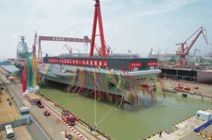 XINHUA VIA AP
                                Coloured smoke mark the launch ceremony for China’s third aircraft carrier christened Fujian at a dry dock in Shanghai on June 17.