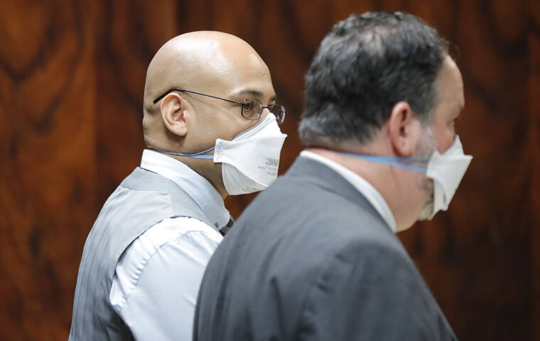 JAMM AQUINO / JAQUINO@STARADVERTISER.COM
                                Gregory Farr, left, stands with defense attorney Marcus Landsberg in circuit court on Thursday in Honolulu. Farr is accused of manslaughter in the shooting death of a neighbor who mistook Farr’s front door as his own.