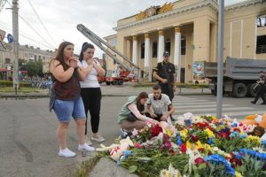 EFREM LUKATSKY / AP
                                People pray and lay flowers at the site of a Russian shelling on Thursday, in Vinnytsia, Ukraine, Friday.