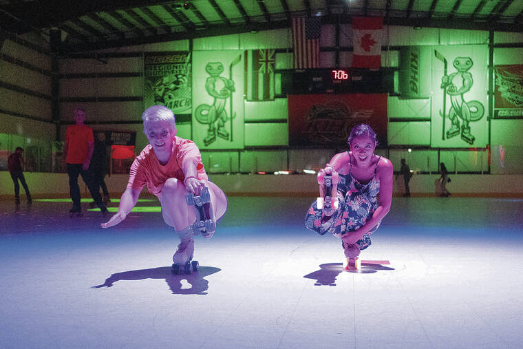 CABLE HOOVER / SPECIAL TO THE STAR-ADVERTISER
                                Chloe Wichryk, left, and Harmony Moses synchronize their moves at the ­Kapolei Inline Hockey Arena.
