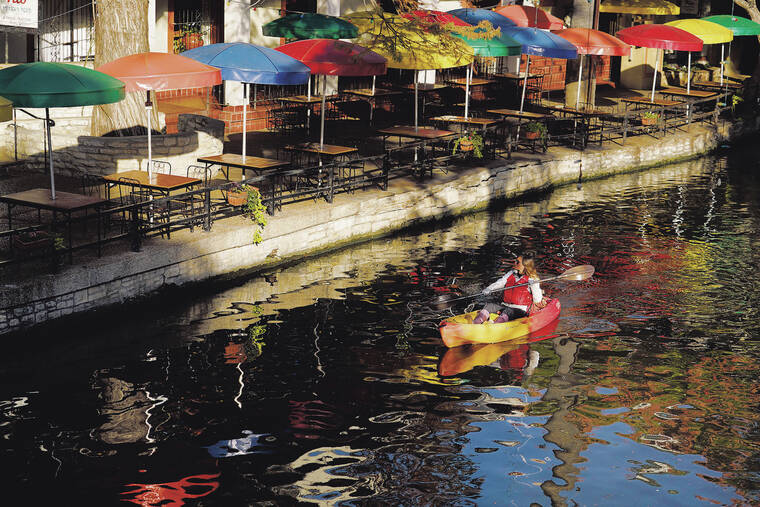 ASSOCIATED PRESS / 2020
                                A kayaker paddles along the River Walk in downtown San Antonio. Kayaking can be a great way to sightsee and get some exercise without too much strain. The key is proper paddling technique.