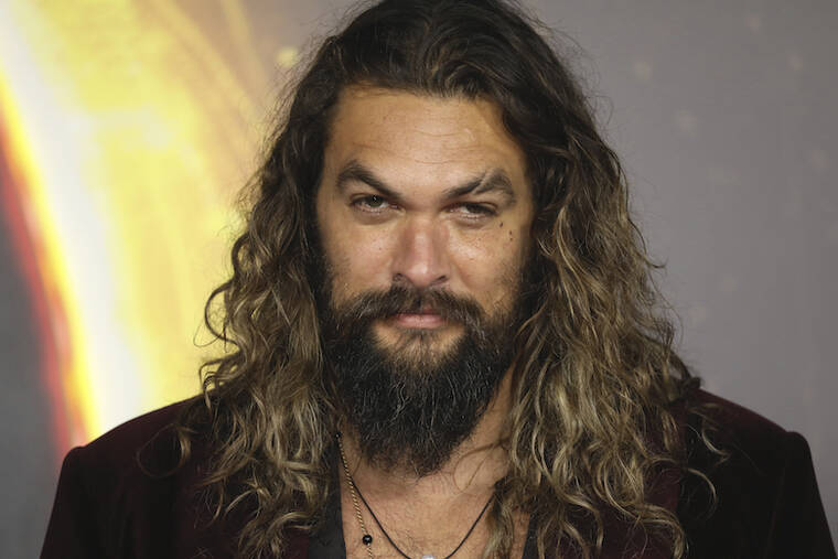 VIANNEY LE CAER/INVISION/AP / 2021
                                Jason Momoa poses for photographers upon arrival at the premiere of the film ‘Dune’ in London.