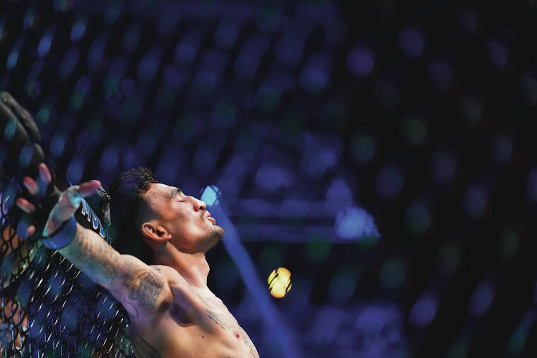 ASSOCIATED PRESS 
                                Max Holloway mentally prepared in the octagon before his fight against Alexander Volkanovski in Saturday’s UFC 276 in Las Vegas.