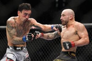 ASSOCIATED PRESS
                                Max Holloway, left, fights Alexander Volkanovski in a featherweight title bout during the UFC 276 mixed martial arts event today.