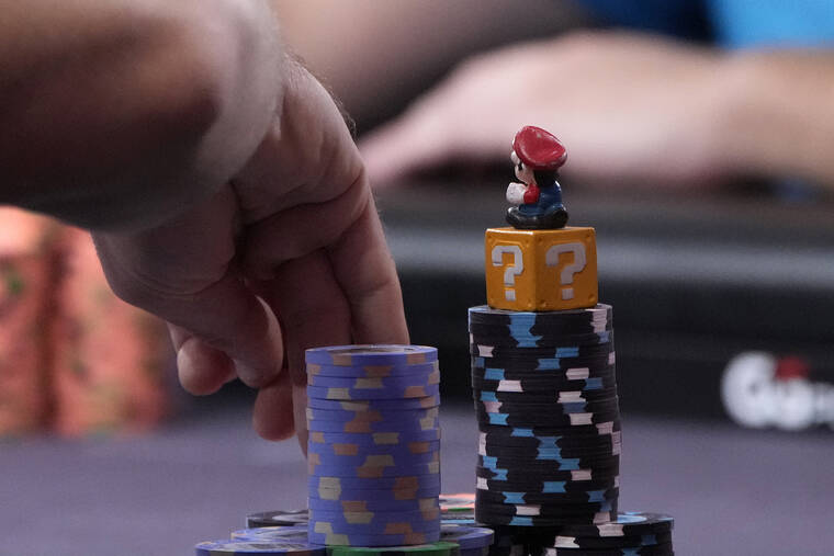 ASSOCIATED PRESS
                                A Super Mario figure rests on the chip stack of Espen Jorstad at the final table during the main event of the the World Series of Poker on Friday.