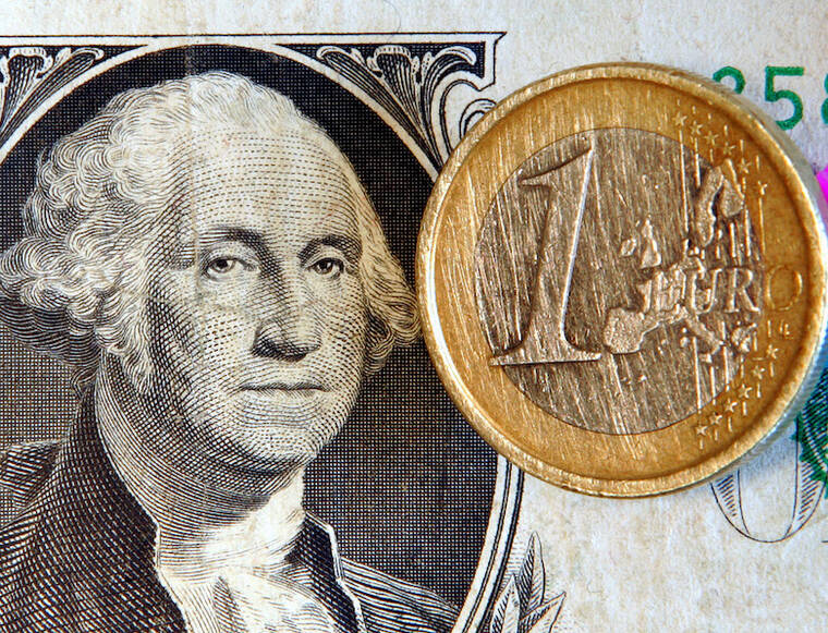 ASSOCIATED PRESS / 2006
                                A one euro coin is seen on a one dollar note in Frankfurt, central Germany.