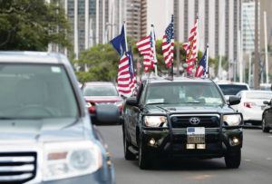 CINDY ELLEN RUSSELL / CRUSSELL@STARADVERTISER.COM
                                A car bedecked in patriotic flags drove through Ala Moana Regional Park during the Fourth of July.