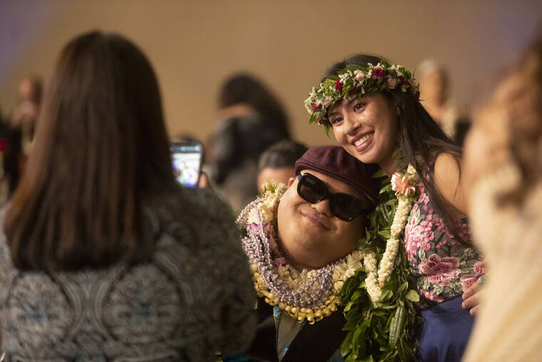 CINDY ELLEN RUSSELL / CRUSSELL@STARADVERTISER.COM
                                Three-time Grammy winner Kalani Pe‘a posed with professional violinist Kimberly Hope for a photo before the start of the 45th Annual Na Hoku Hanohano Awards. Pe‘a took home two awards at the event.