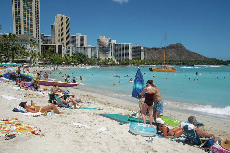 CRAIG T. KOJIMA / 2021
                                Tourists have returned to Waikiki after COVID-19 restrictions eased, but some don’t plan a repeat visit anytime soon, citing the high cost of vacationing in the isles. Beachgoers enjoy the sand and ocean near the Royal Hawaiian Hotel.