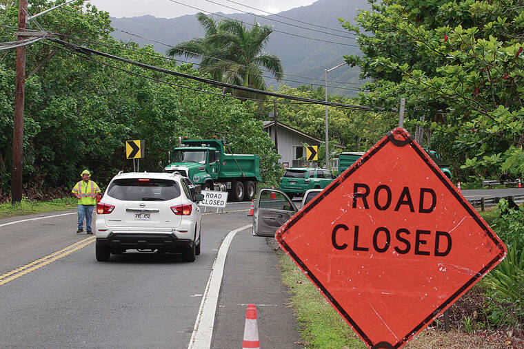JAMM AQUINO / JAQUINO@STARADVERTISER.COM
                                Road closure signs were seen Monday on Kameha­meha Highway just before Trout Farm Road in Kaha­na. The Board of Water Supply continues to work on a water main break that caused the highway’s closure in both directions at Kahana Bay.